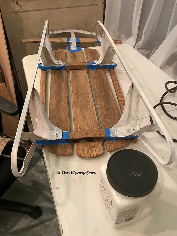 vintage sled taped with painters tape and painted with a coat of slick stick