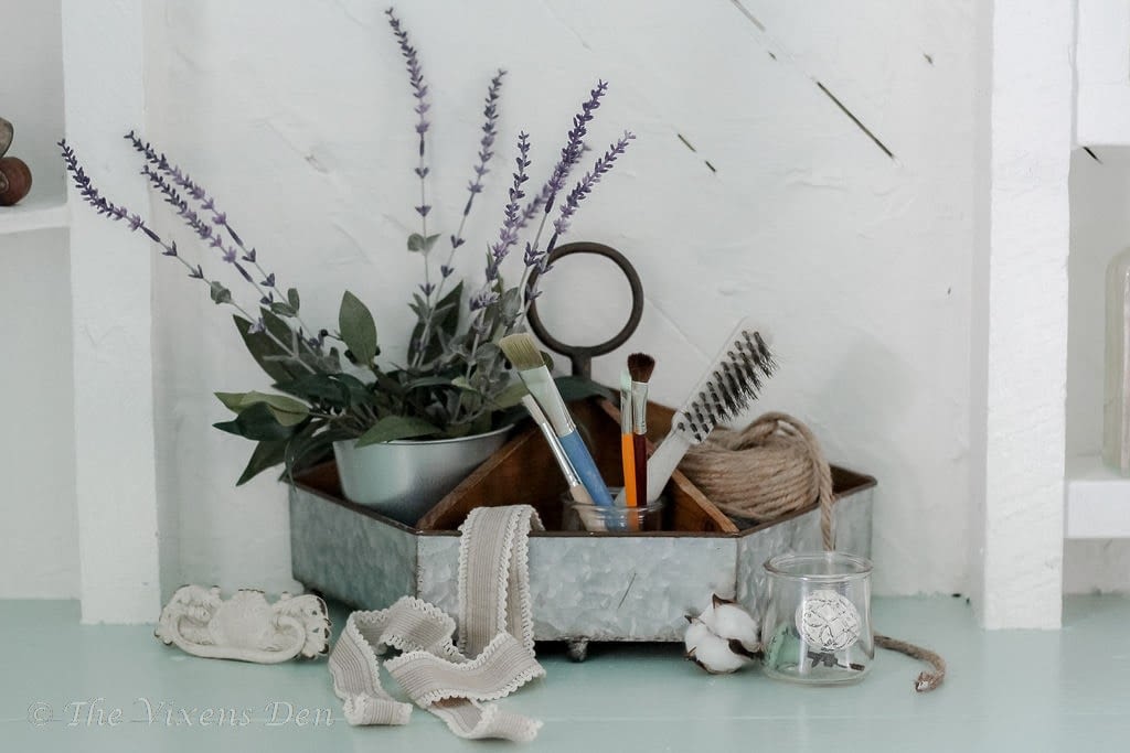 organizer with lavender stalks, paintbrushes, jute cord, and hardware