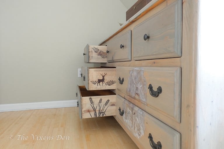 dresser stained to look like raw wood with DIY transfer and stenciled drawer sides