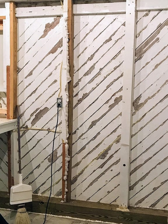 wood slat walls with gaps between boards and spray foam