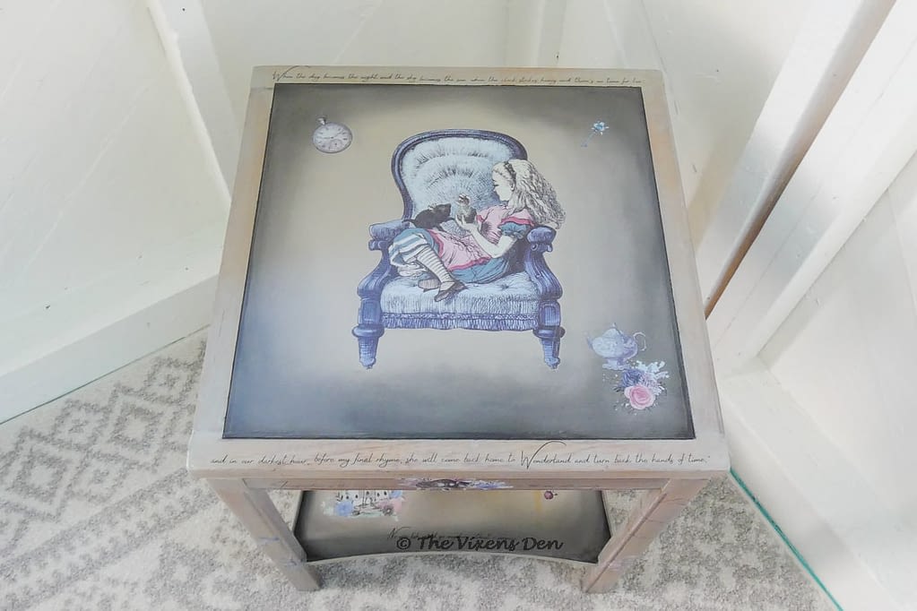 view of painted side table with Alice in Wonderland transfers and quotes from the story