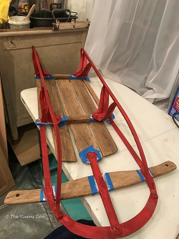 vintage sled runners with first coat of rustic red chalk paint