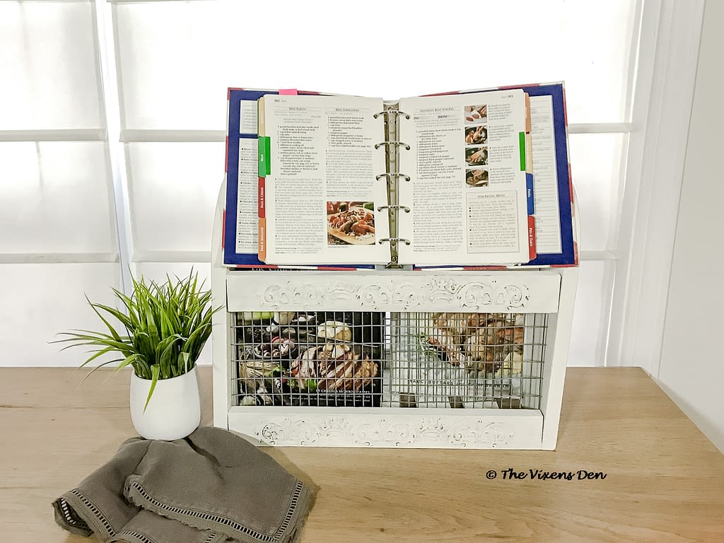 repurposed magazine rack staged as a cookbook caddy